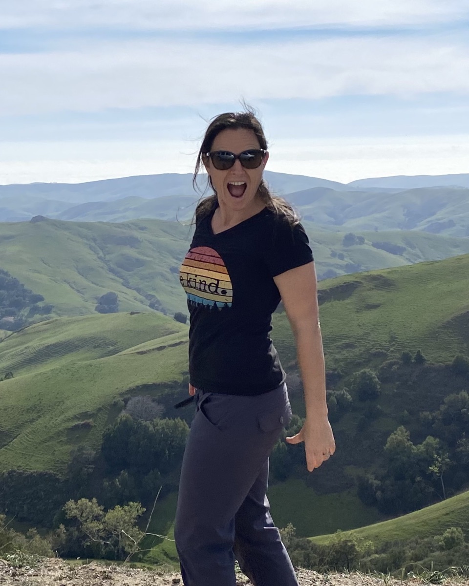 Erin hiking in the green hills of the Central Coast